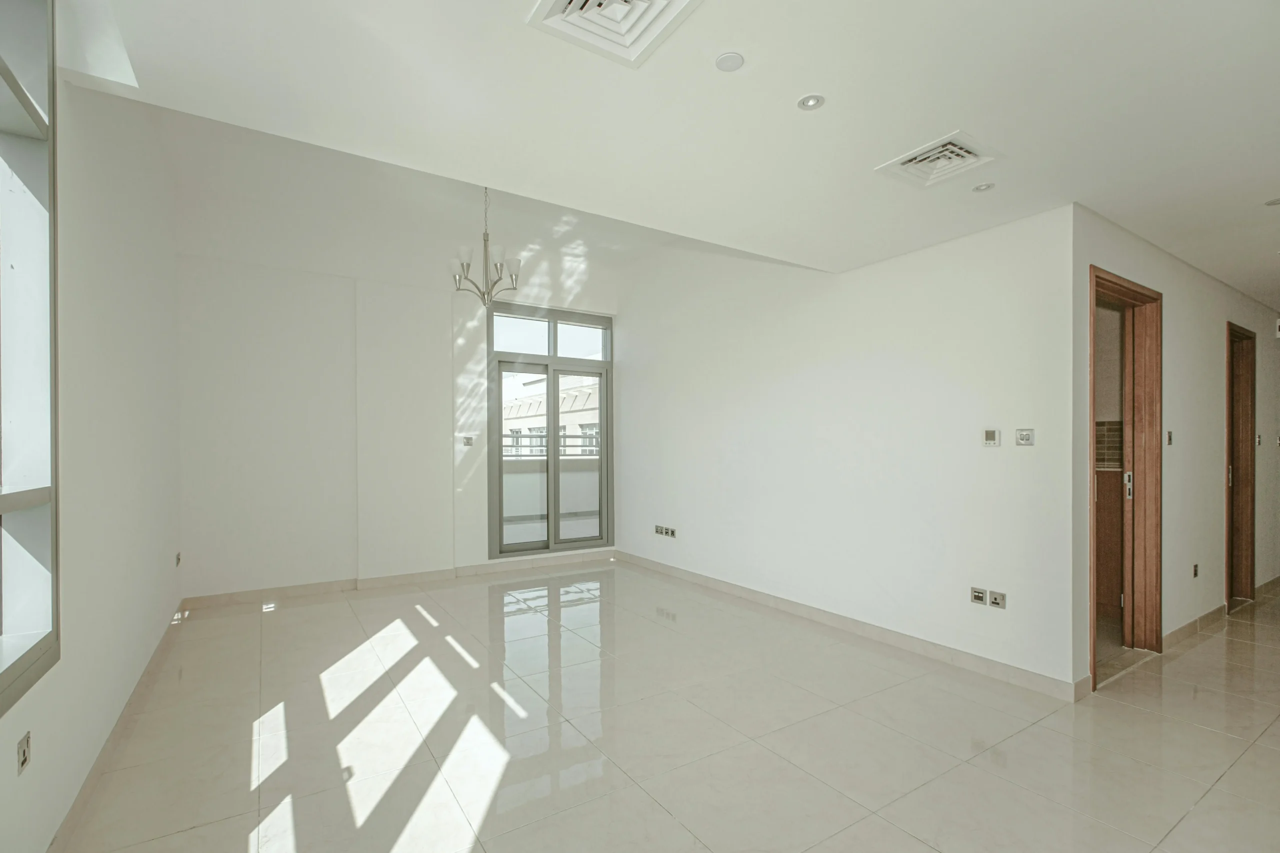 Empty rental room with clean flooring and neat windows after detailed end of lease cleaning.